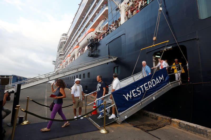 Passengers leave MS Westerdam, a cruise ship that spent two weeks at sea after being turned away by five countries over fears that someone aboard might have the coronavirus, as it docks in Sihanoukville