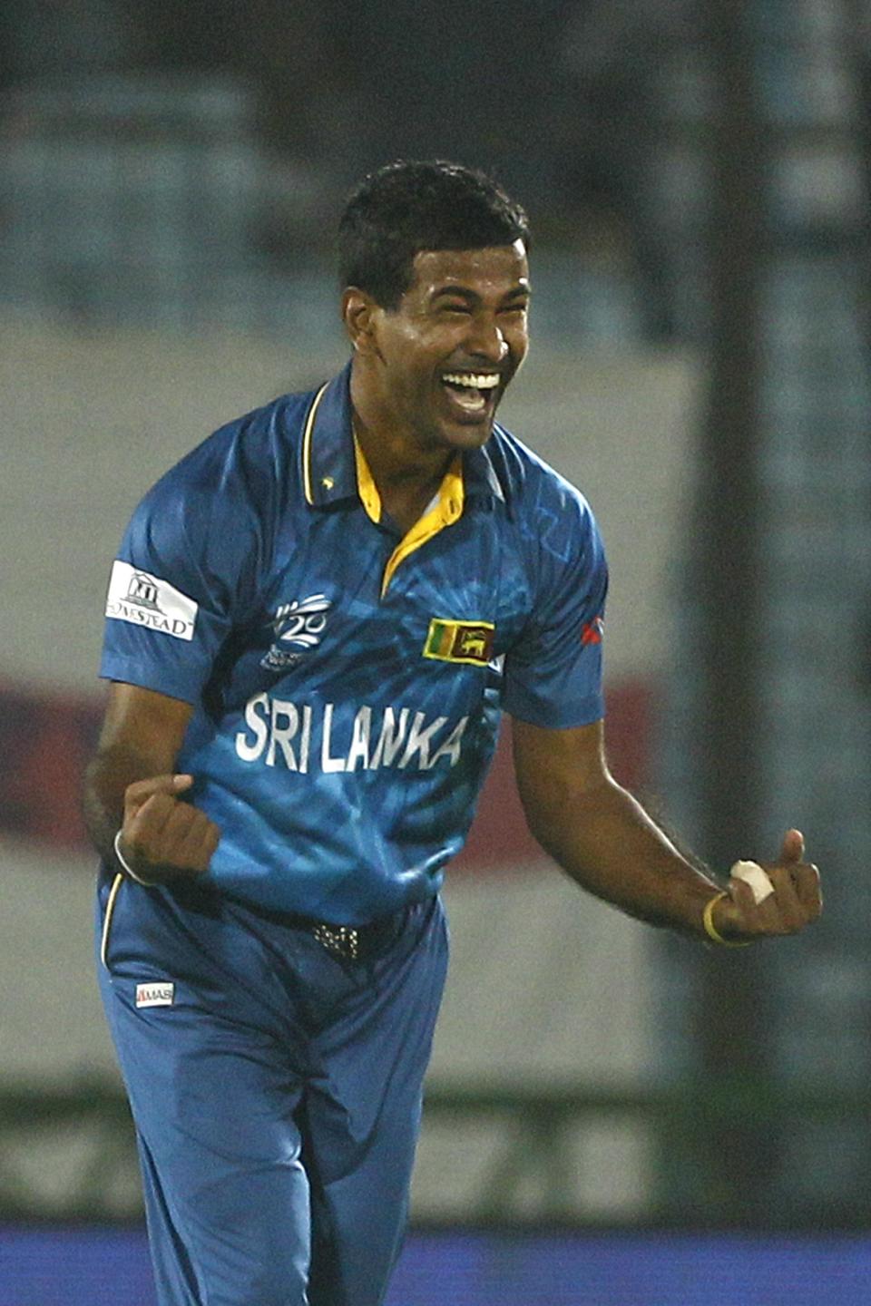 Sri Lanka's Nuwan Kulasekara celebrates the dismissal of England's Moeen Ali during their ICC Twenty20 Cricket World Cup match in Chittagong, Bangladesh, Thursday, March 27, 2014. (AP Photo/A.M. Ahad)