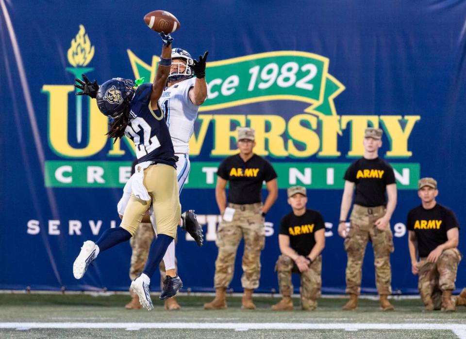 FIU Panthers defensive back Brian Blades (22) blocks a throw to Maine Black Bears wide receiver Montigo Moss (81) in the second quarter of their NCAA DI football game at the FIU Football Stadium on Saturday, Sept. 2, 2023, in Miami, Fla.