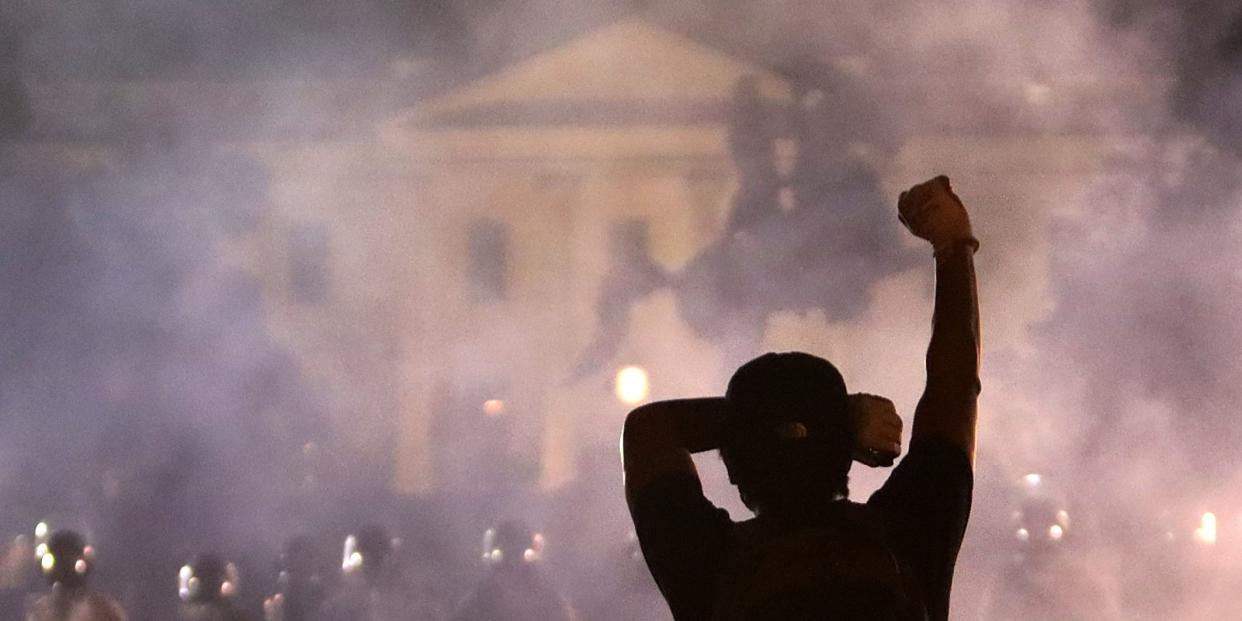 WASHINGTON, DC - MAY 31: A man holds up his fist during a protest near the White House on May 31, 2020 in Washington, DC. Minneapolis police officer Derek Chauvin was arrested for Floyd's death and is accused of kneeling on Floyd's neck as he pleaded with him about not being able to breathe. Floyd was pronounced dead a short while later. Chauvin and three other officers, who were involved in the arrest. (Photo by Alex Wong/Getty Images)