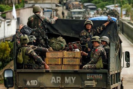 Philippines army soldiers ride in trucks into the fighting zone as government troops continue their assault against insurgents from the Maute group in Marawi City, Philippines June 28, 2017. REUTERS/Jorge Silva