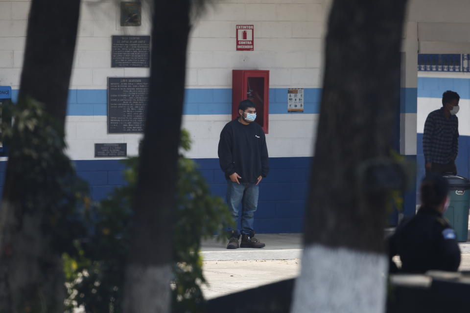 A deported man stands inside an athletic dorm facility where Guatemalans returned from the U.S. are being held in Guatemala City, Friday, April 17, 2020. The recently deported Guatemalans were placed here to wait for the results of their tests for the new coronavirus. (AP Photo/Moises Castillo)