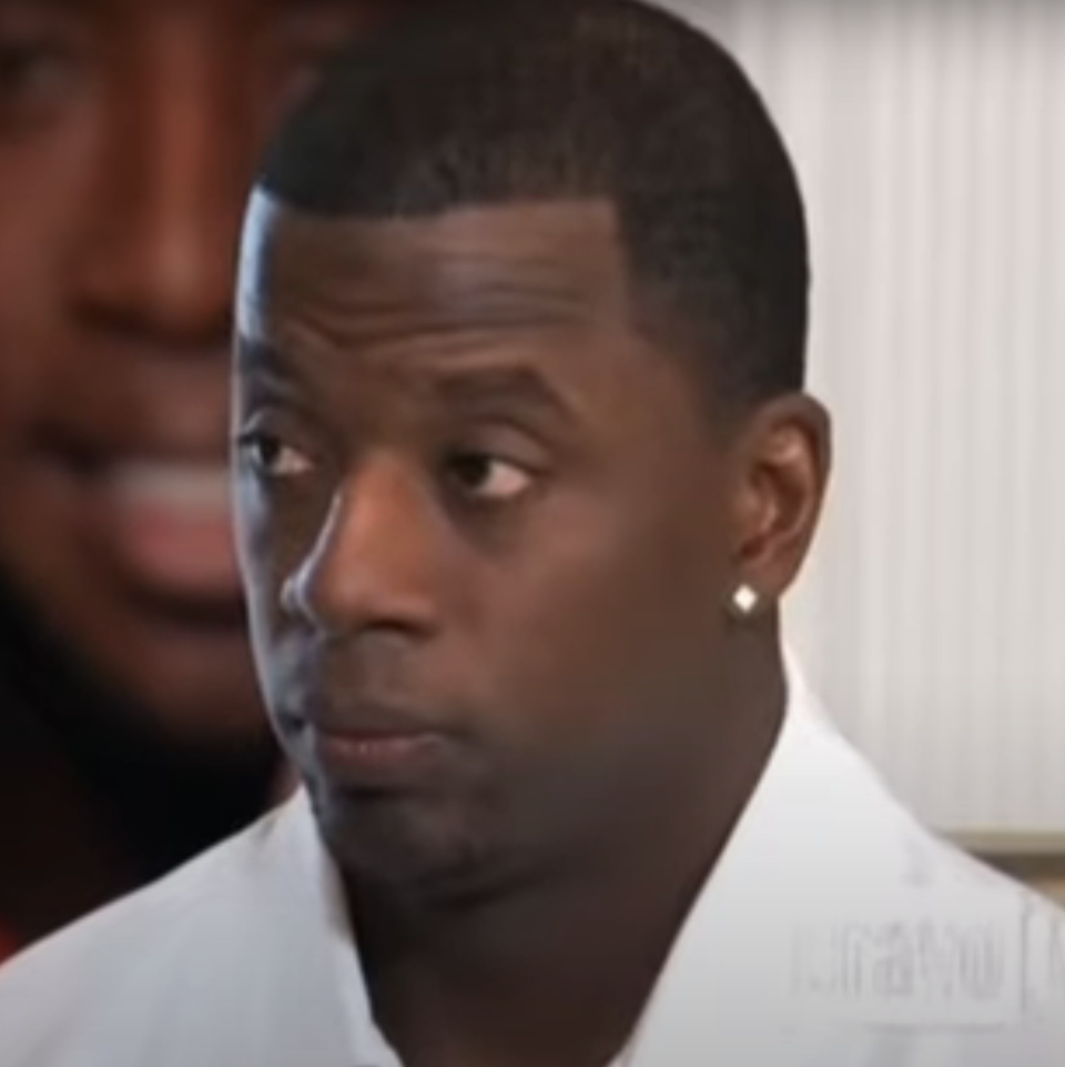 Kordell Stewart sitting in conversation, wearing a collared shirt and earrings