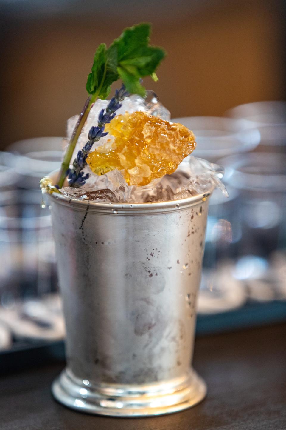 Mixologist Natalie White's "The Lucky Debonair" spin on a Four Roses mint julep during the Kentucky Derby Festival's Festival Unveiled event Wednesday evening at the Mellwood Arts Center. March 16, 2022