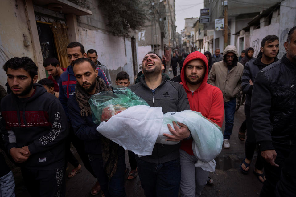 Mohammad Shouman carries the body of his daughter, Masa, who was killed in an Israeli bombardment of the Gaza Strip, during her funeral in Rafah, southern Gaza, on Jan. 17.<span class="copyright">Fatima Shbair—AP</span>