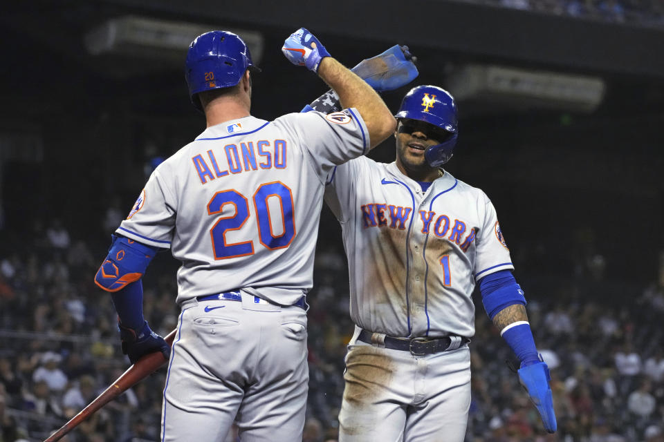 New York Mets' Jonathan Villar celebrates with Pete Alonso (20) after scoring on a triple by Francisco Lindor during the sixth inning of the team's baseball game against the Arizona Diamondbacks, Tuesday, June 1, 2021, in Phoenix. (AP Photo/Rick Scuteri)