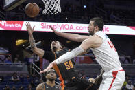 Orlando Magic guard Cole Anthony (50) goes up for a shot as Los Angeles Clippers center Ivica Zubac (40) defends during the first half of an NBA basketball game, Wednesday, Jan. 26, 2022, in Orlando, Fla. (AP Photo/Phelan M. Ebenhack)