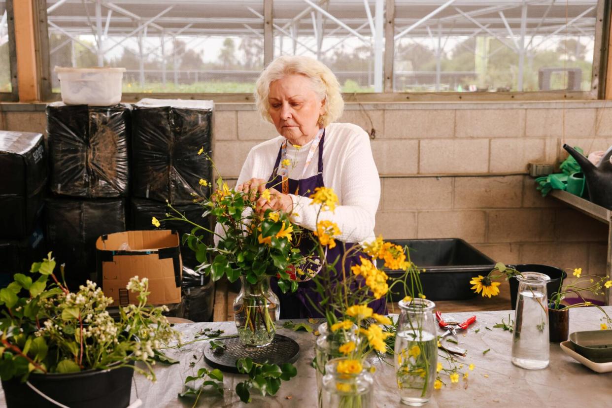 Susan Spradley assembles a bouquet made from native flowers from California Botanic Garden