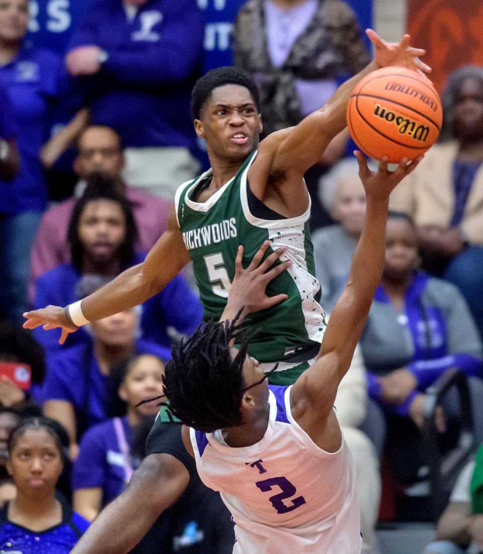 Richwoods' Jared Jackson, top, blocks Harvey Thornton's Chase Abraham in the second half of their Class 3A boys basketball supersectional Monday, March 4, 2024 at Ottawa High School. The Knights advanced to the state semifinals with a 58-52 win.