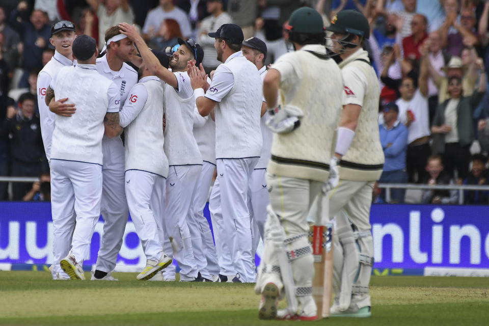 England players celebrate the dismissal of Australia's Steven Smith, right, during the first day of the third Ashes Test match between England and Australia at Headingley, Leeds, England, Thursday, July 6, 2023. (AP Photo/Rui Vieira)