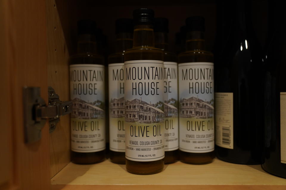 Bottles of Mountain House Olive Oil, produced by former California Gov. Jerry Brown are displayed at Brown's home near Williams, Calif., Saturday, Oct. 30, 2021. (AP Photo/Rich Pedroncelli)