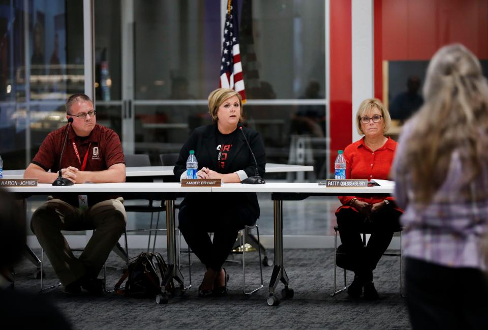 Ozark school board member Amber Bryant answers a question Tuesday during a town hall meeting.