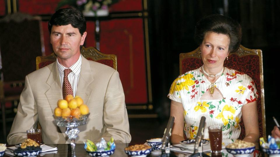 Princess Anne and Timothy Laurence sitting at a dinner table 