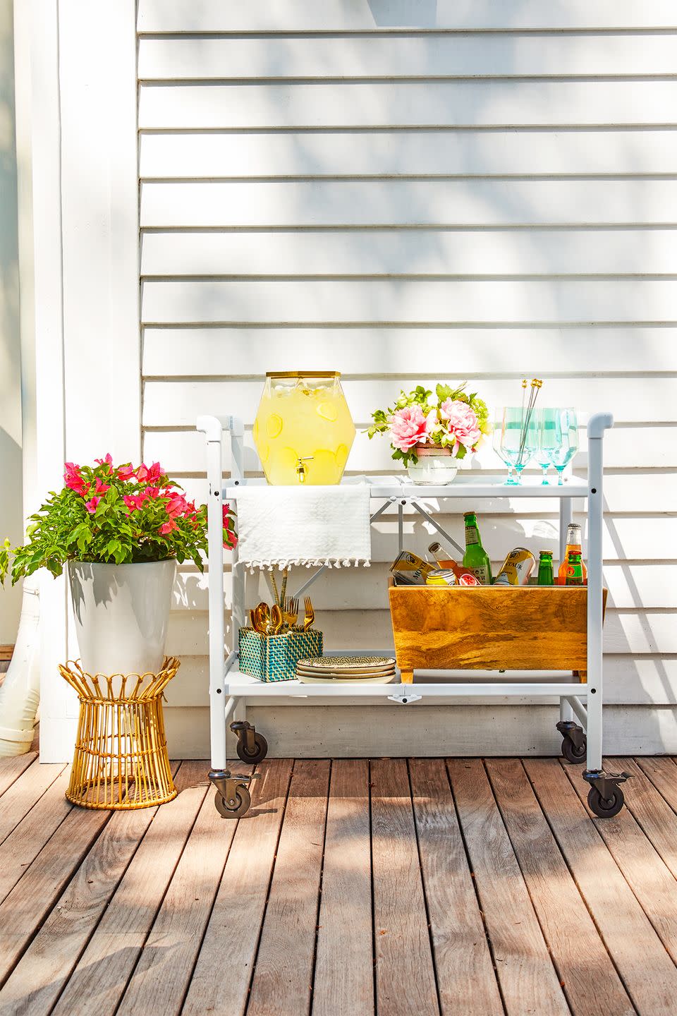 <p>When done right, utility carts become the ultimate drink station. Deck out the shelves with coolers, glasses, utensils and pitchers full of party punch (or another drink of your choice). </p>