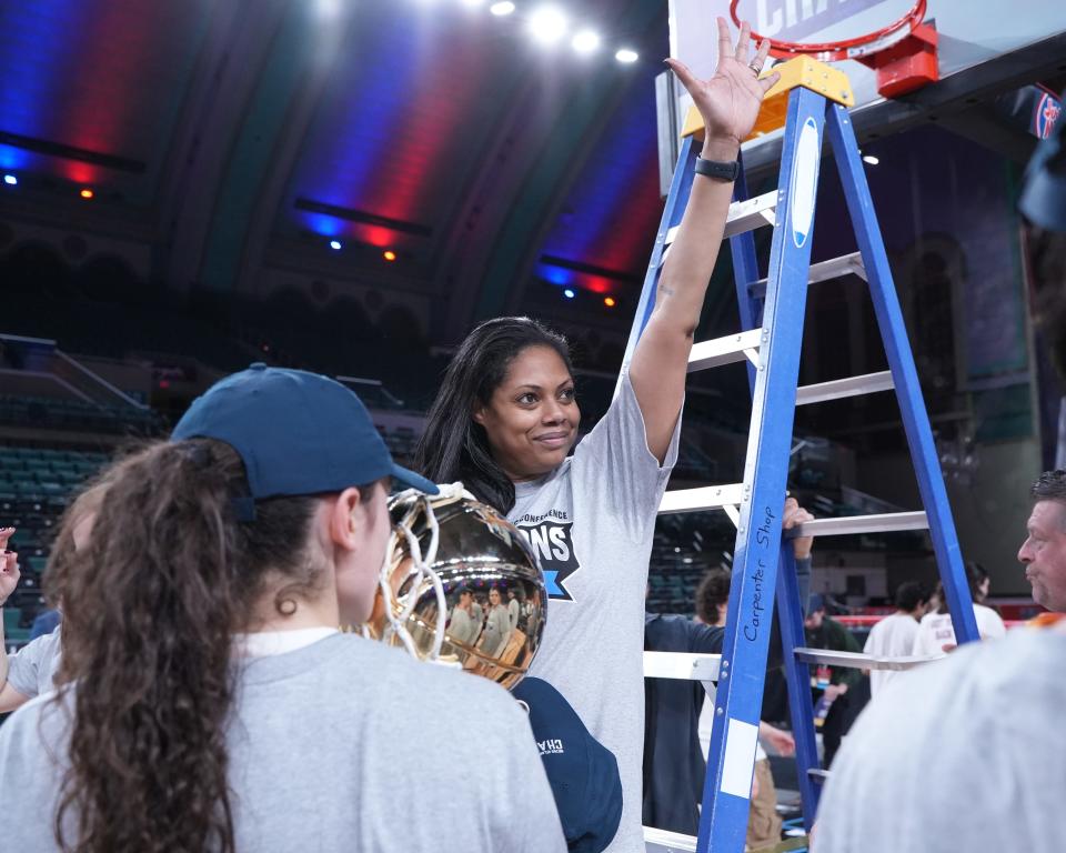 Iona coach Billi Chambers waves to the crowd after cutting down the net following the Gaels' MAAC Tournament title win at Boardwalk Hall in Atlantic City on Saturday, March 11, 2023.