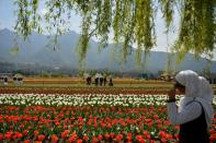 <p>Kashmiri college students visit the Tulip Garden in Srinagar on March 29, 2016. Containing some 1.2 million tulip bulbs, official say the garden is Asia’s largest, spread over 12 hectares. The garden was first opened for tourists in 2008 and stays open for over a month every spring. </p>