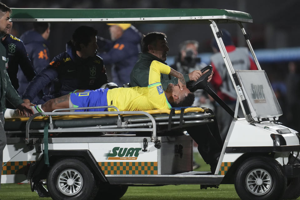 Brazil's Neymar is carried off the pitch on a stretcher after being injured during a qualifying soccer match for the FIFA World Cup 2026 against Uruguay at Centenario stadium in Montevideo, Uruguay, Tuesday, Oct. 17, 2023. (AP Photo/Matilde Campodonico)