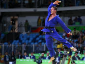 <p>Dirk Van Tichelt of Belgium celebrates winning a bronze medal in 73kg judo on August 8, 2016. (REUTERS/Kai Pfaffenbach) </p>