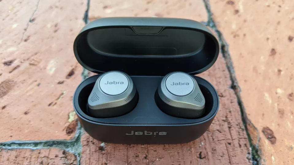 The Jabra Elite 85t sitting on a brick floor