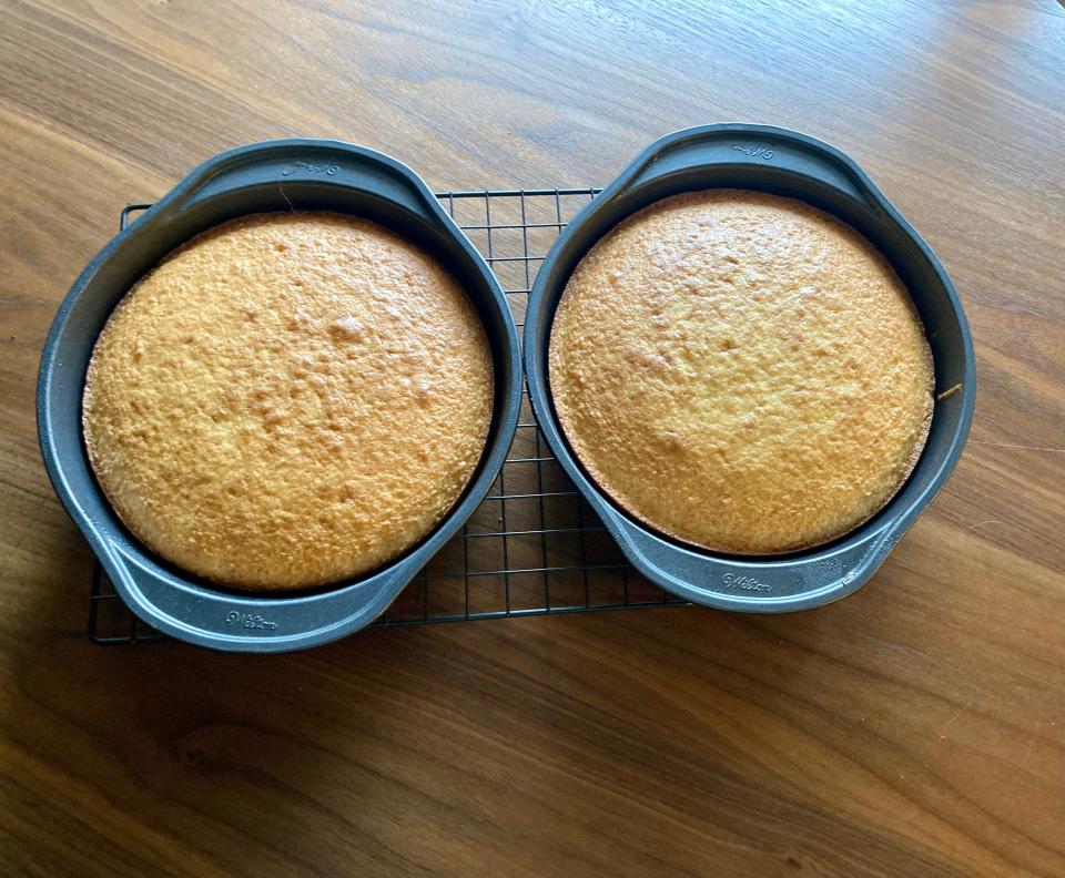 Duncan Hines cake mix in 9-inch rounds on a cooling rack on a wood table