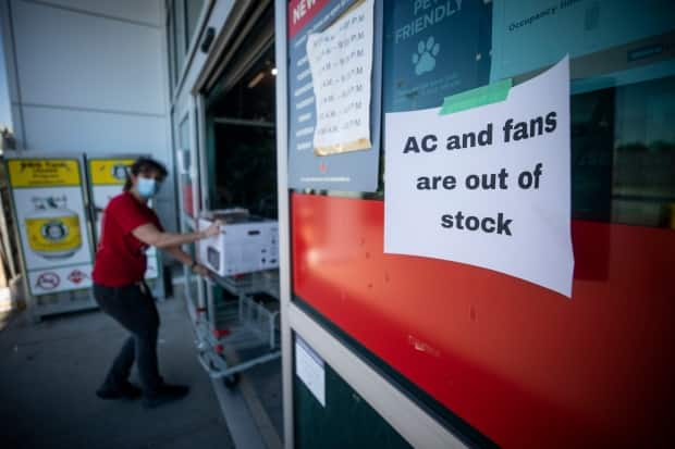 Canadian Tire in Vancouver posted a sign stating they were sold out of air conditioning units and fans on June 28. (Ben Nelms/CBC - image credit)