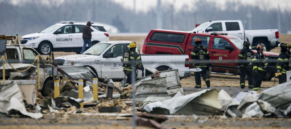 Authorities respond after a partial building collapse at Beechcraft aircraft manufacturing facility in Wichita, Kan., Friday, Dec. 27, 2019. More than a dozen people were injured Friday when a nitrogen line ruptured at the facility, causing part of the building to collapse, authorities said. (Travis Heying/The Wichita Eagle via AP)