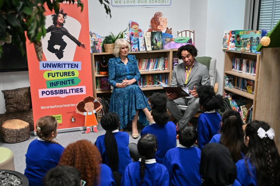 Queen Camilla and pupils listen to Waterstones Children's Laureate and poet Joseph Coelho reading a poem in the library (Justin Tallis/PA Wire)