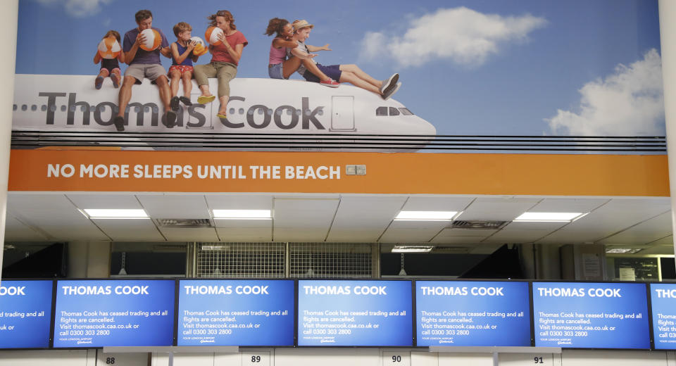 Empty Thomas Cook check-in desk in Gatwick Airport, England Monday, Sept. 23, 2019. British tour company Thomas Cook collapsed early Monday after failing to secure emergency funding, leaving tens of thousands of vacationers stranded abroad. (AP Photo/Alastair Grant)