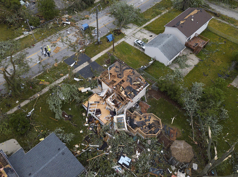 Debris litters the ground around damaged homes after a tornado ripped through the suburbs in Woodridge, Ill., Monday, June 21, 2021. (Mark Welsh/Daily Herald via AP)