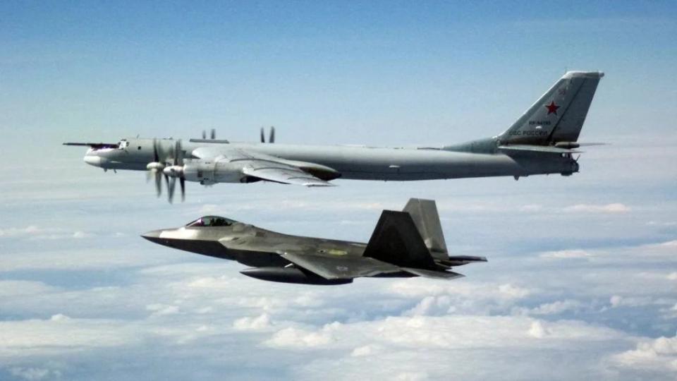 A picture showing a previous intercept of a Russian Tu-95 off Alaska by a US Air Force F-22 Raptor stealth fighter. <em>USAF</em>