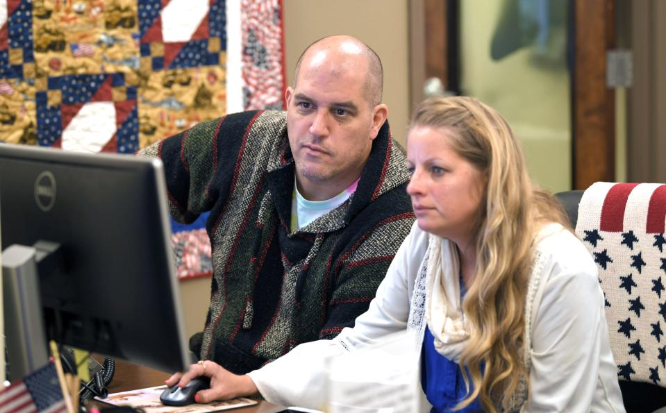 The Charlie and Hazel Daniels Veterans and Military Family Center office manager and veteran Elizabeth Wilburn helps Army veteran and MTSU student Chuck Bolding at the  Charlie and Hazel Daniels Veterans and Military Family Center at MTSU on Thursday, Oct. 31, 2019. 