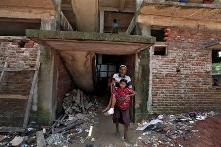 Rohingya refugees leave a temporary medical clinic in a derelict building at Cox's Bazar, Bangladesh, September 26, 2017. REUTERS/Cathal McNaughton