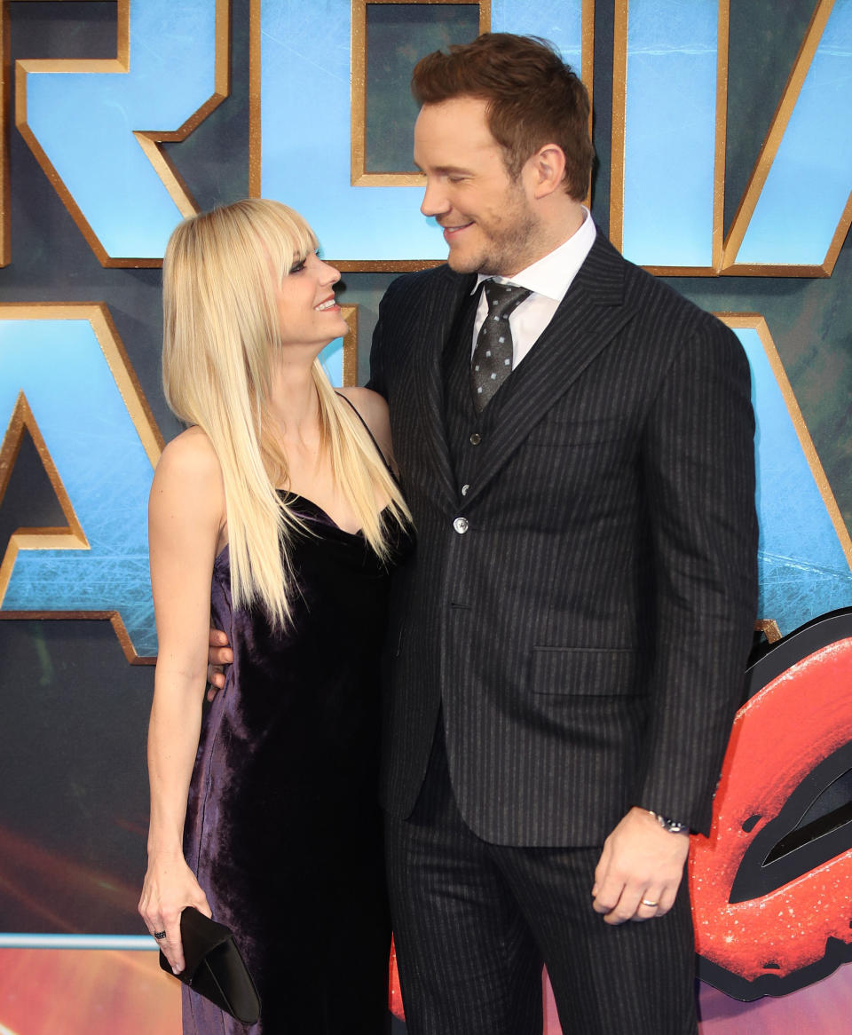 Anna Faris and Chris Pratt smile at each other at an event