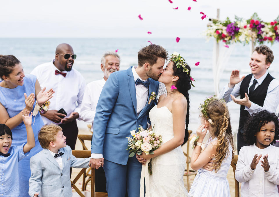 Young couple kissing at wedding reception