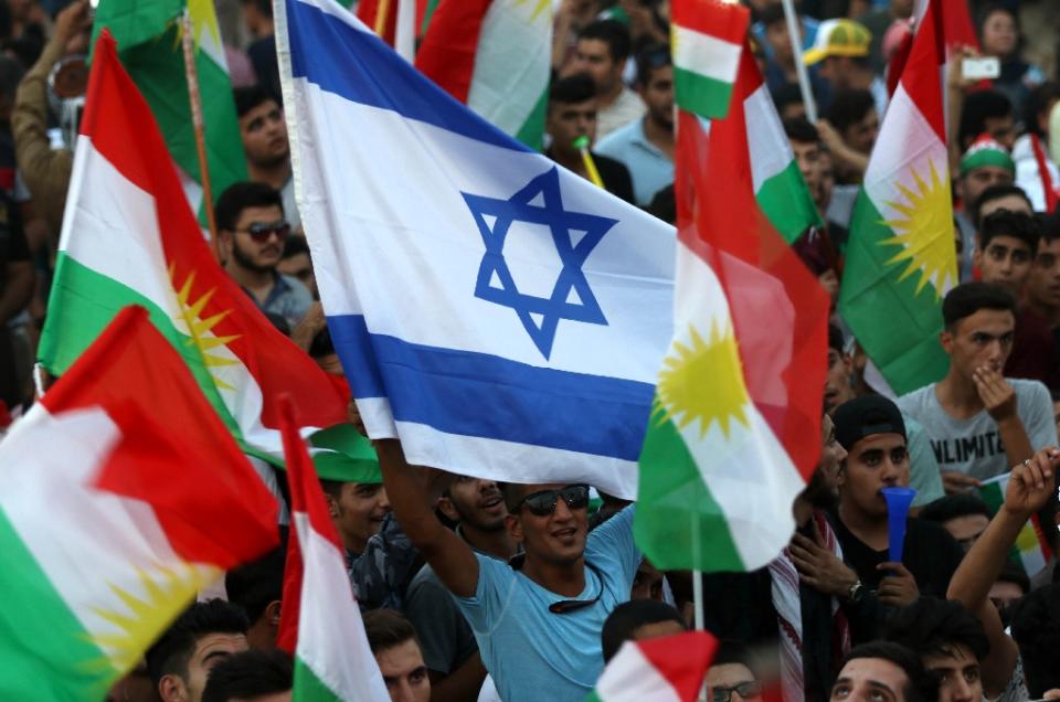 <p>An Israeli flag is waved alongside Kurdish flags during an event in Iraqi Kurdistan’s capital of Arbil on Sept. 16, 2017, to urge people to vote in a Sept. 25 independence referendum. (Photo: Safin Hamed/AFP/Getty Images) </p>