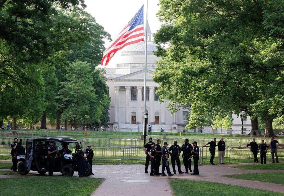 Law enforcement gathers next to a barrier on the quad of UNC-Chapel Hill hours after police detained members of a pro-Palestinian “Gaza solidarity encampment” early Tuesday morning, April 30, 2024, after warning the group to remove its tents from university grounds or face possible arrest, suspension or expulsion from the university.
