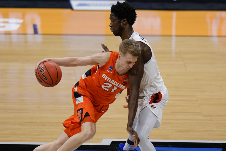 Syracuse forward Marek Dolezaj, left, runs into San Diego State forward Nathan Mensah during the second half of a college basketball game in the first round of the NCAA tournament at Hinkle Fieldhouse in Indianapolis, Friday, March 19, 2021. (AP Photo/AJ Mast)