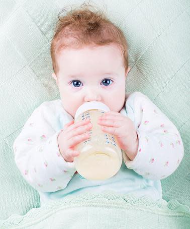 baby with plastic bottle