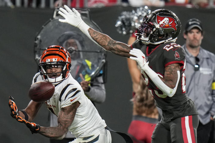 Cincinnati Bengals wide receiver Ja'Marr Chase (1) drops a pass against Tampa Bay Buccaneers cornerback Sean Murphy-Bunting (23) during the second half of an NFL football game, Sunday, Dec. 18, 2022, in Tampa, Fla. (AP Photo/Chris O'Meara)