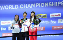 Silver medalist Hali Flickinger of the United States, left, gold medalist Summer McIntosh of Canada, centre, bronze medalist Yufei Zhang of China, right, pose with their medals after the Women 200m Butterfly final at the 19th FINA World Championships in Budapest, Hungary, Wednesday, June 22, 2022. (AP Photo/Petr David Josek)