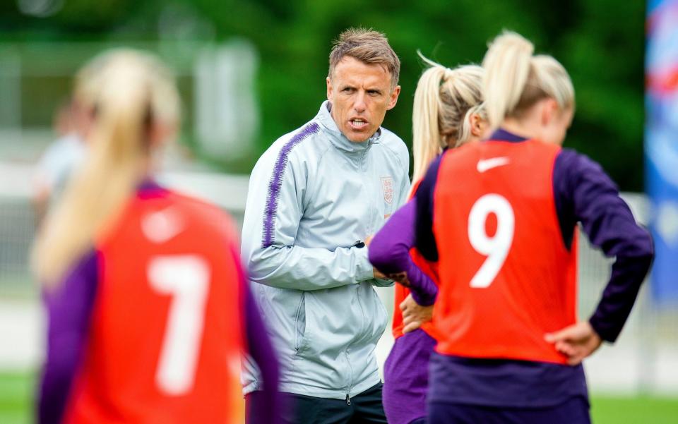 Phil Neville puts his England players through their paces in training - REX