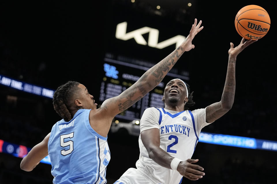 Kentucky forward Aaron Bradshaw (2) shoots against North Carolina forward Armando Bacot (5) during the first half of an NCAA college basketball game in the CBS Sports Classic, Saturday, Dec. 16, 2023, in Atlanta, Ga. (AP Photo/Brynn Anderson)