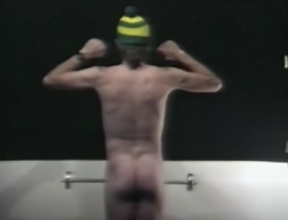 the man's backside as he lifts a dumb bell
