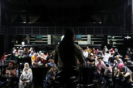 Staff at Boshe VVIP Club listen to a sermon by Mifta'im An'am Maulana Habiburrohman, or Gus Miftah, a 37-year-old Muslim preacher who aims to create a safe space to worship for those who work in the entertainment industry, in Kuta, Bali, Indonesia November 27, 2018. REUTERS/Nyimas Laula/Files