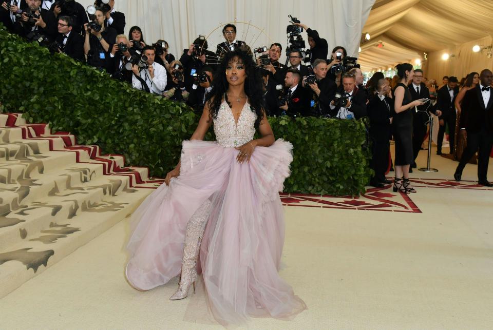 <p>Singer SZA made the night her own in this Versace lavender gown with matching thigh-high boots. Photo: Getty Images </p>