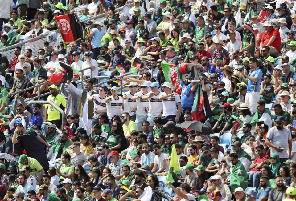 Cricket fans cheer for their teams during the Cricket World Cup match between Pakistan and Afghanistan at Headingley in Leeds, England, Saturday, June 29, 2019. (AP Photo/Rui Vieira)