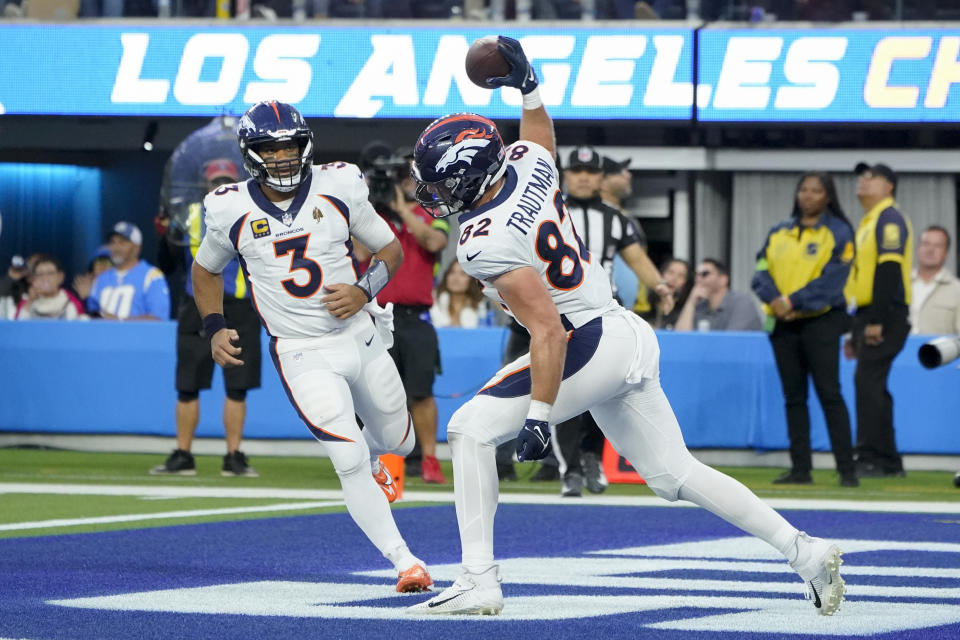 Denver Broncos tight end Adam Trautman (82) celebrates his touchdown as quarterback Russell Wilson (3) approaches to congratulate him during the second half of an NFL football game against the Los Angeles Chargers Sunday, Dec. 10, 2023, in Inglewood, Calif. (AP Photo/Marcio Jose Sanchez)