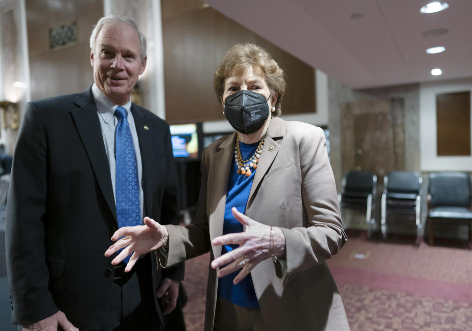 Sen. Jeanne Shaheen, D-N.H., right, who chairs the Senate Foreign Relations Subcommittee on Europe and Regional Security Cooperation, is joined at left by Sen. Ron Johnson, R-Wis., left, as they greet witnesses at a hearing at the Capitol in Washington, Wednesday, Feb. 16, 2022. Senators of both parties have been eager to show a unified front from the U.S. as tensions rise on Ukraine's border with Russia and will try to pass a non-binding resolution that calls on President Joe Biden to "impose significant costs" on Russia if it invades Ukraine. (AP Photo/J. Scott Applewhite)