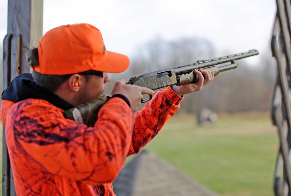 Random Lake High School student Nicholas Daggett aims a shotgun during a skeet shooting session during a wilderness science class, Wednesday, November 9, 2022, in Cascade, Wis.