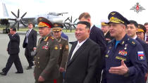 In this image made from video released by Russian Defense Ministry Press Service, North Korea's leader Kim Jong Un, center, with Russian Defense Minister Sergei Shoigu, left, inspects Russian warplanes at the Vladivostok International airport in Vladivostok, Russian Far East on Saturday, Sept. 16, 2023. (Russian Defense Ministry Press Service via AP)